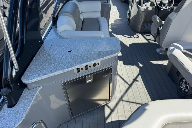 Slide: The Image of 2023 Avalon Excalibur 27' boat interior with seating and kitchenette area. - 13