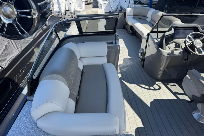 Slide: The Image of 2023 Avalon Excalibur 27' boat interior with luxurious seating and modern dashboard. - 18