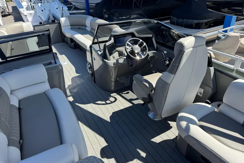 Slide: The Image of Interior of 2023 Avalon Excalibur 27' boat with luxurious seating and modern helm. - 19