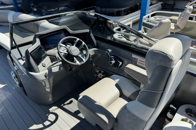 Slide: The Image of 2023 Avalon Excalibur 27' boat cockpit with modern steering and controls. - 20