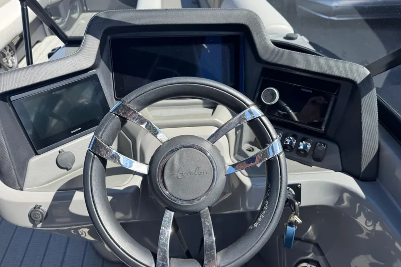 Slide: The Image of Steering wheel and dashboard of 2023 Avalon Excalibur 27' boat. - 21