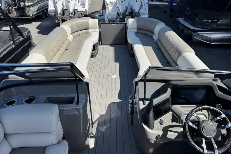 Slide: The Image of 2023 Avalon Excalibur 27' pontoon boat interior with luxurious seating and modern helm. - 22