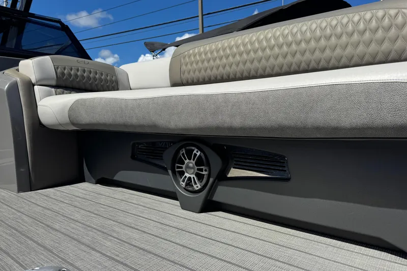 Slide: The Image of 2023 Avalon Excalibur 27' boat interior with luxurious seating and speaker system. - 27