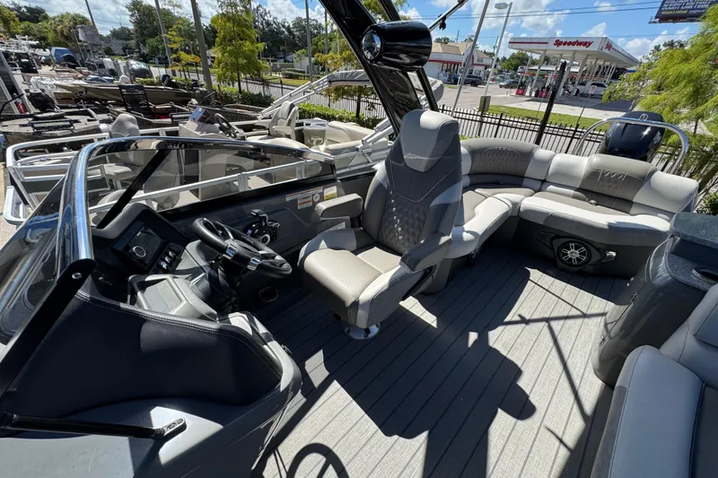 Slide: The Image of 2023 Avalon Excalibur 27' boat interior with luxurious seating and modern dashboard. - 33