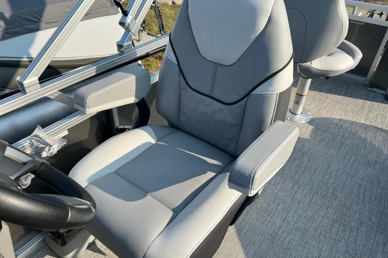 Slide: The Image of 2026 Tahoe Pontoon 2180 REAR FISH boat seat with gray upholstery and armrests. - 11