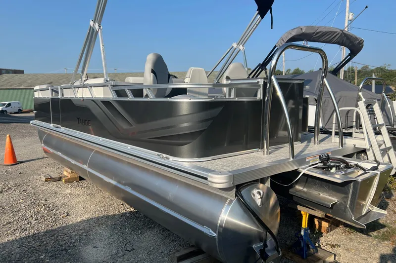 Slide: The Image of 2026 Tahoe Pontoon 2180 REAR FISH boat on display in outdoor setting. - 13