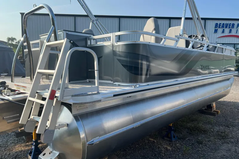 Slide: The Image of 2026 Tahoe Pontoon 2180 REAR FISH boat with ladder, parked outdoors. - 15