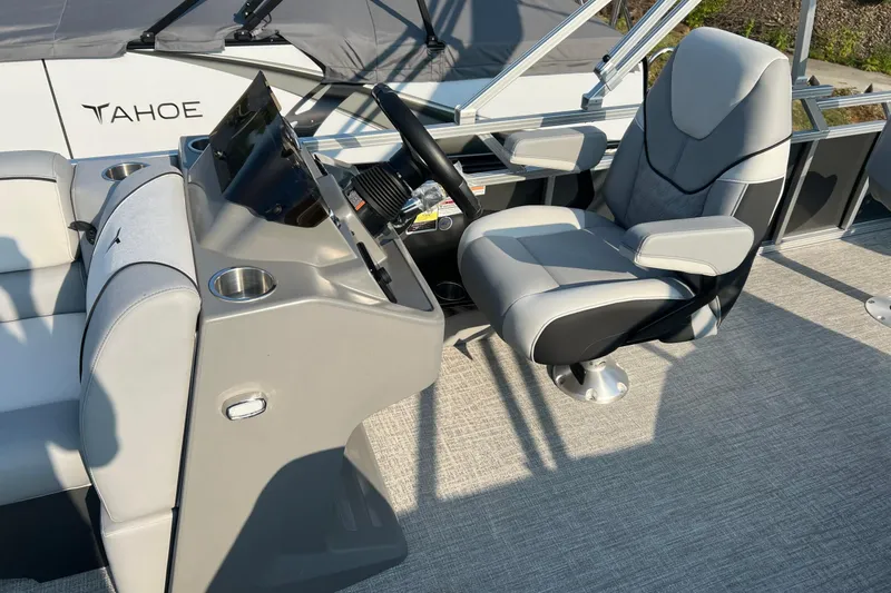 Slide: The Image of 2026 Tahoe Pontoon 2180 REAR FISH boat interior with captain's chair and control panel. - 21