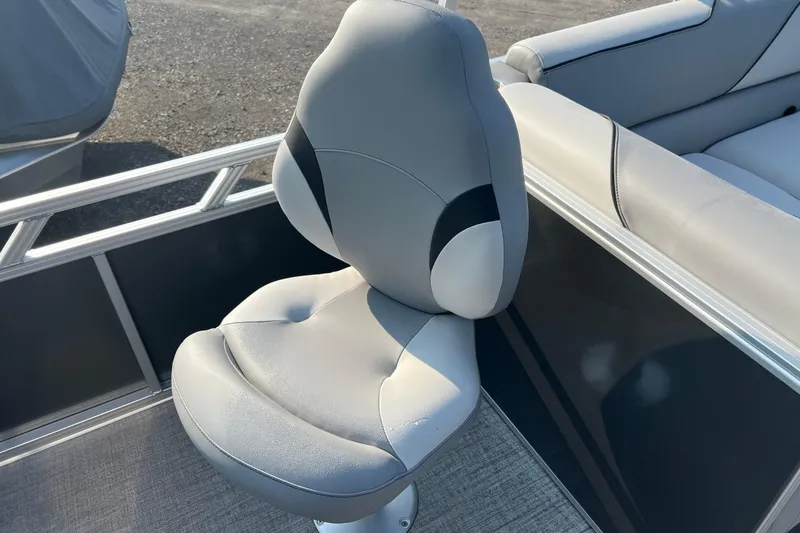 Slide: The Image of 2026 Tahoe Pontoon 2180 REAR FISH boat seat, gray upholstery, outdoor setting. - 4
