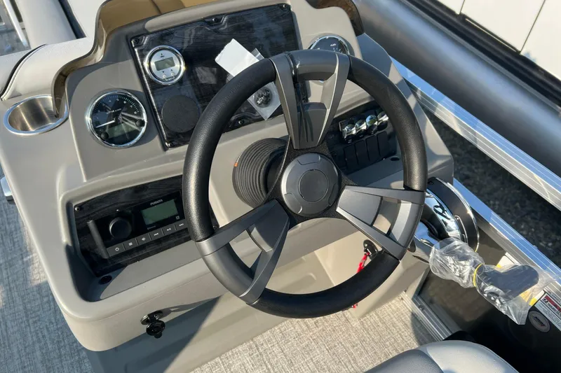 Slide: The Image of Steering console of 2026 Tahoe Pontoon 2180 REAR FISH with gauges and controls. - 7