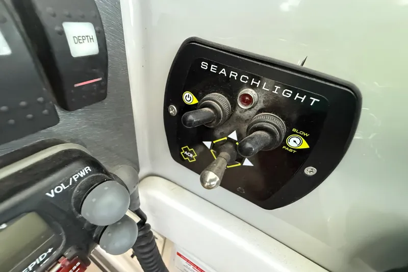 Slide: The Image of Control panel of a 2004 Formula 400 Super Sport boat with searchlight switches. - 12