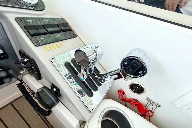 Slide: The Image of Control panel of a 2004 Formula 400 Super Sport boat with chrome throttle levers. - 13