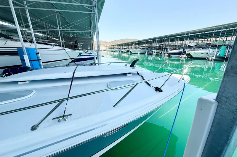 Slide: The Image of 2004 Formula 400 Super Sport boat docked in a marina with turquoise water. - 4
