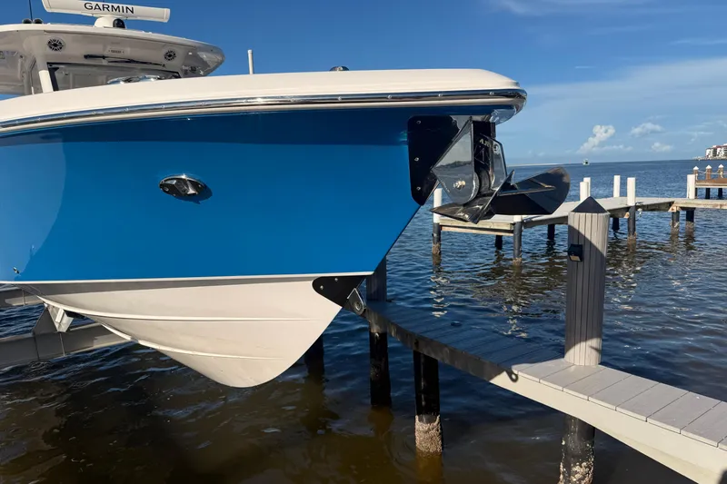 Slide: The Image of 2023 Everglades 395 Center Console boat docked by the water on a sunny day. - 10