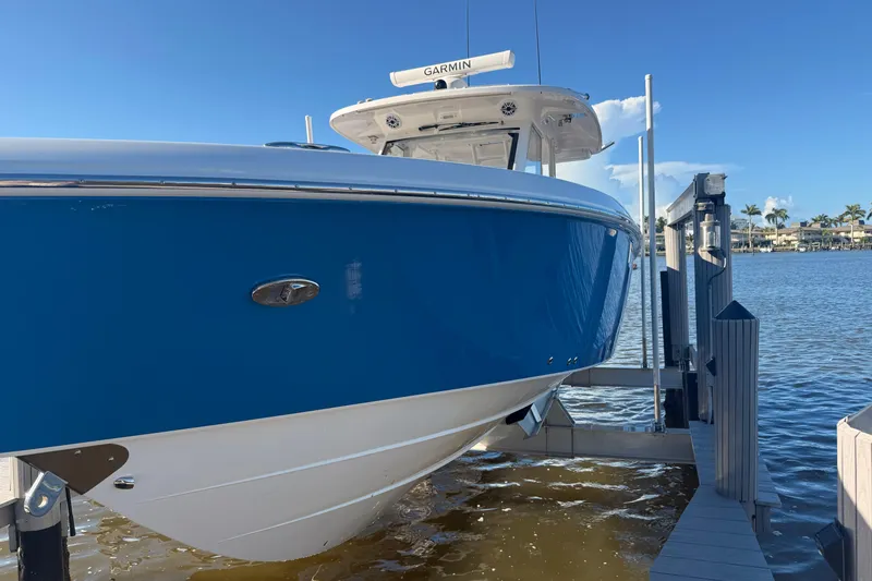 Slide: The Image of 2023 Everglades 395 Center Console boat docked on a sunny day. - 11
