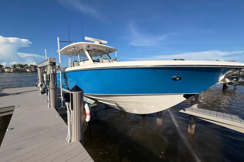 Slide: The Image of 2023 Everglades 395 Center Console boat docked on a sunny day. - 15