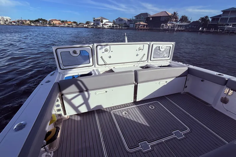 Slide: The Image of 2023 Everglades 395 Center Console boat with spacious deck and waterfront view. - 22