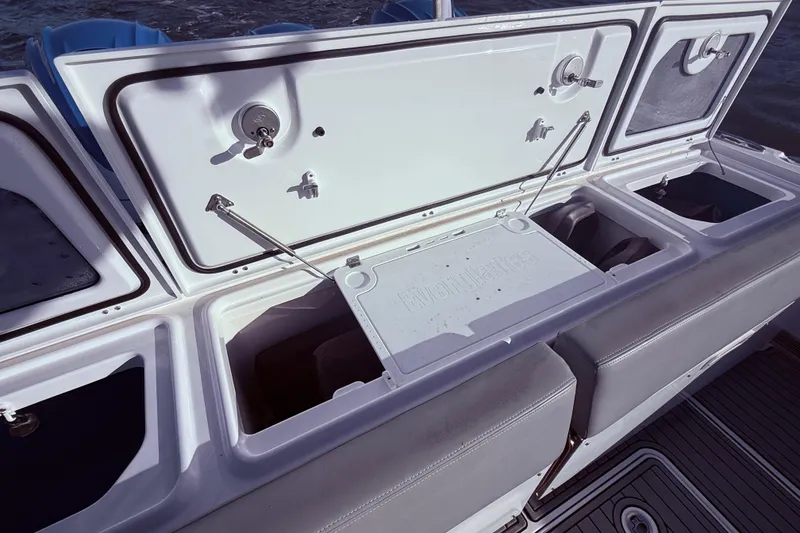 Slide: The Image of 2023 Everglades 395 Center Console boat with open storage compartments. - 24