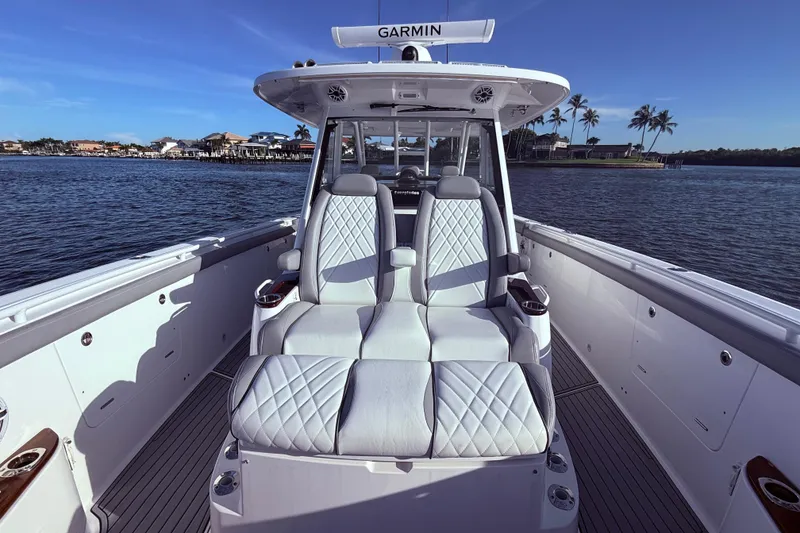 Slide: The Image of 2023 Everglades 395 Center Console boat interior with luxurious seating on calm water. - 30