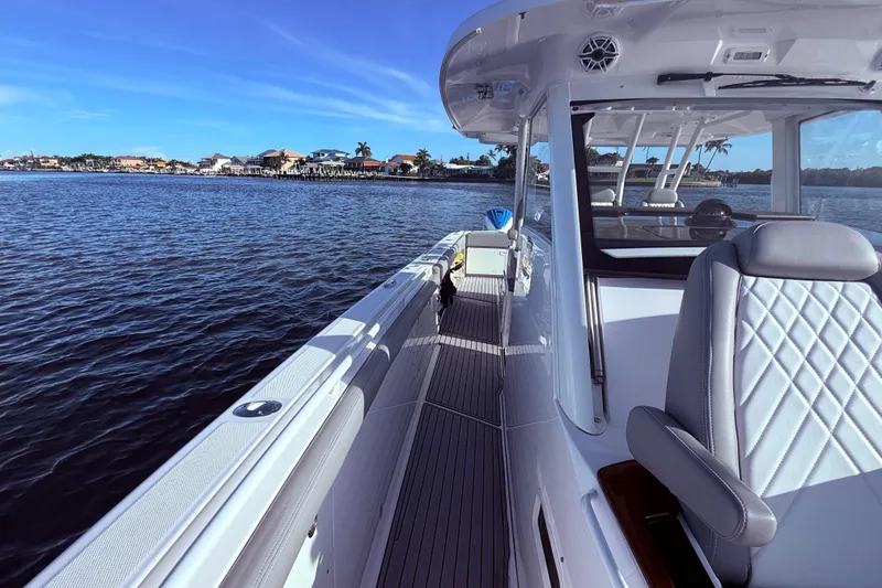 Slide: The Image of 2023 Everglades 395 Center Console boat on calm water, coastal view. - 31