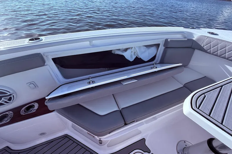 Slide: The Image of 2023 Everglades 395 Center Console boat interior with seating and storage compartment. - 33