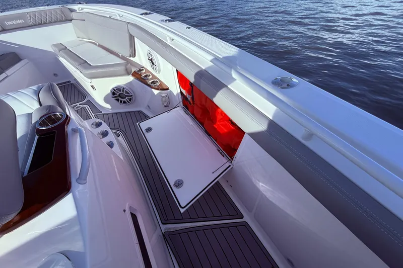 Slide: The Image of 2023 Everglades 395 Center Console boat interior with seating and storage compartments. - 36