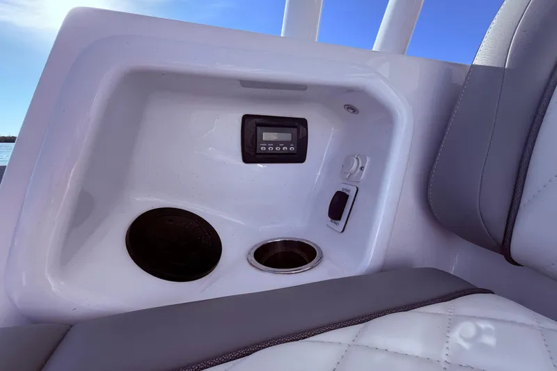 Slide: The Image of 2023 Everglades 395 Center Console interior with control panel and cup holders. - 41