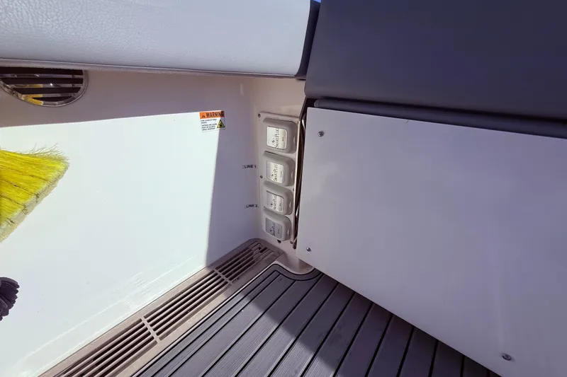 Slide: The Image of 2023 Everglades 395 Center Console boat interior with control panel and warning label. - 43