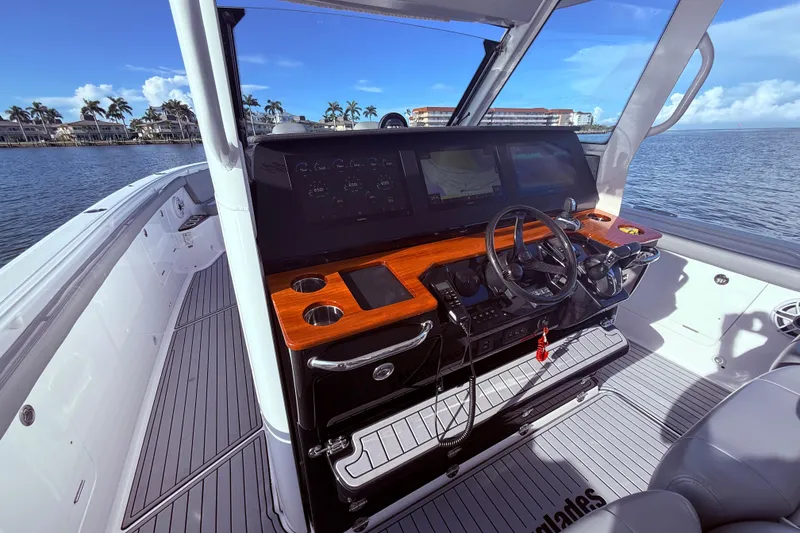 Slide: The Image of 2023 Everglades 395 Center Console boat interior with modern helm and navigation displays. - 47