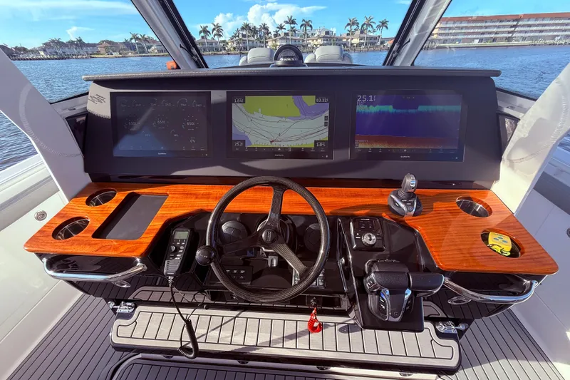 Slide: The Image of 2023 Everglades 395 Center Console helm with advanced navigation displays and controls. - 49