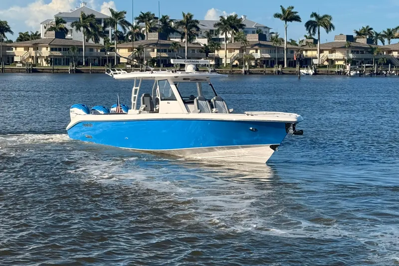 Slide: The Image of 2023 Everglades 395 Center Console boat cruising on a sunny waterfront. - 5