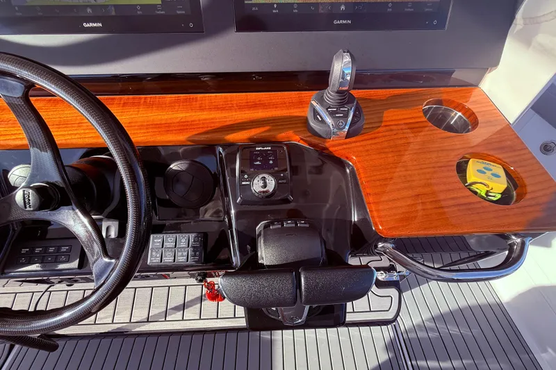 Slide: The Image of 2023 Everglades 395 Center Console dashboard with steering wheel and navigation controls. - 50