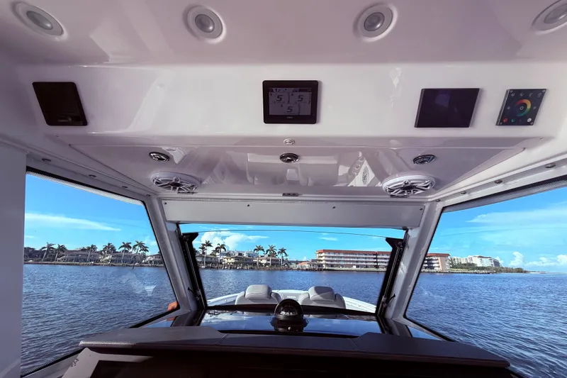 Slide: The Image of Interior view of 2023 Everglades 395 Center Console boat with waterfront scenery. - 52
