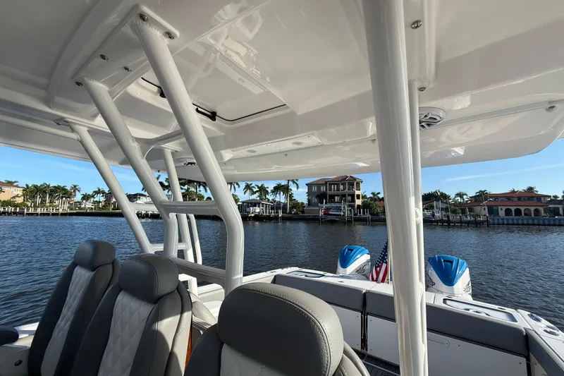 Slide: The Image of 2023 Everglades 395 Center Console boat interior with waterfront view. - 58