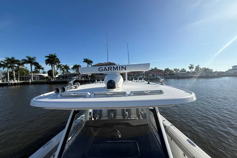 Slide: The Image of 2023 Everglades 395 Center Console boat with Garmin equipment on a sunny waterfront. - 59