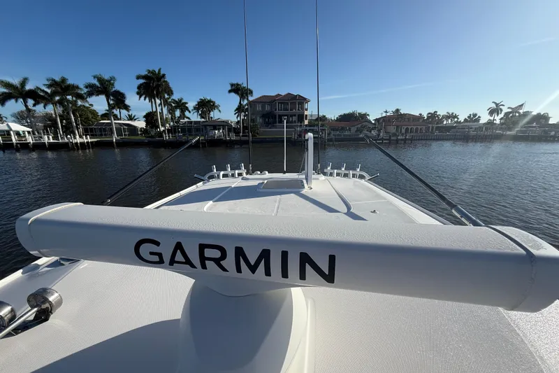 Slide: The Image of 2023 Everglades 395 Center Console boat with Garmin equipment, docked near waterfront homes. - 60