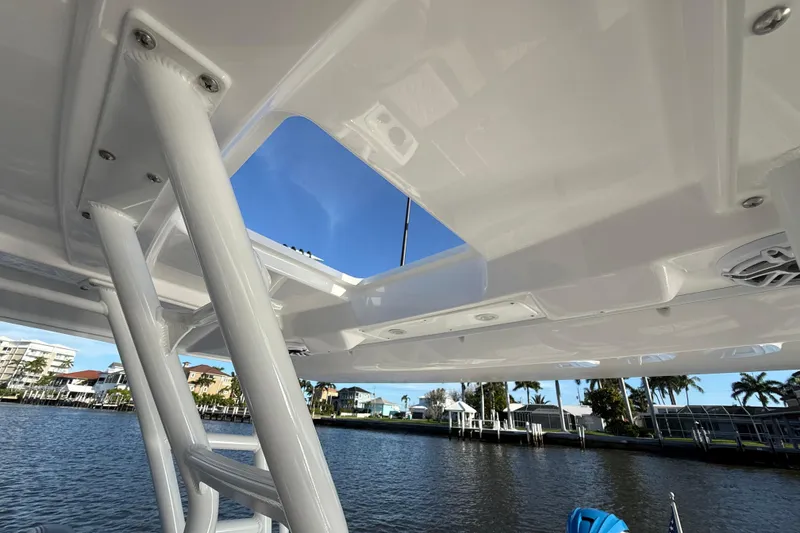 Slide: The Image of 2023 Everglades 395 Center Console boat roof with clear sky and waterfront view. - 62