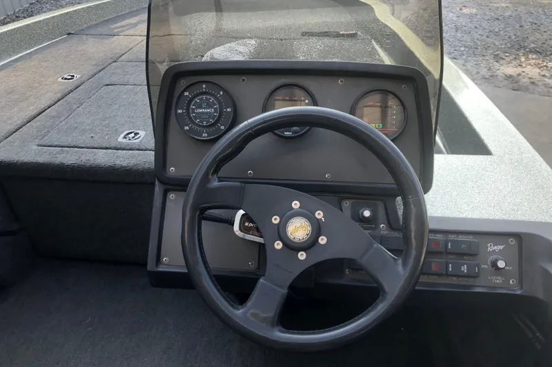 Slide: The Image of 1993 Ranger Comanche 482v boat dashboard with steering wheel and instrument panel. - 10