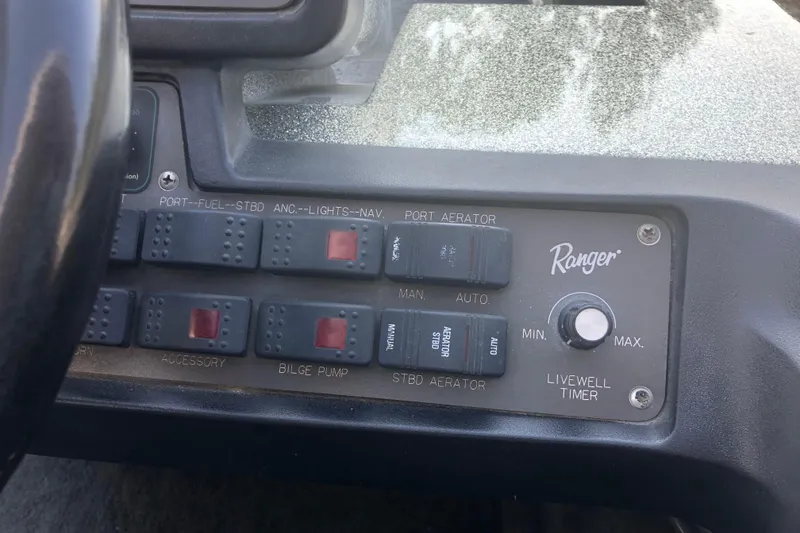 Slide: The Image of Control panel of a 1993 Ranger Comanche 482v boat with switches and dials. - 12