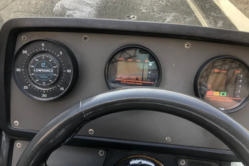 Slide: The Image of Dashboard of a 1993 Ranger Comanche 482v boat with marine gauges. - 16