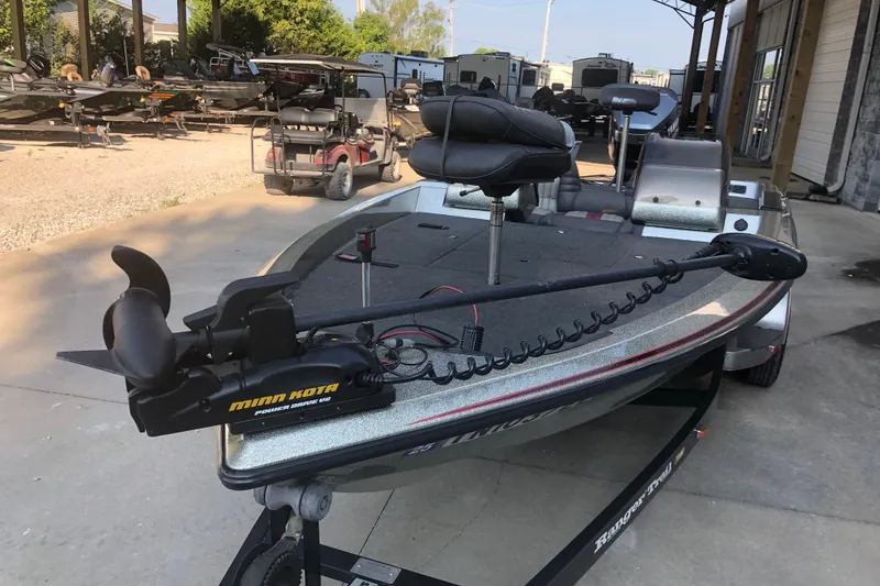 Slide: The Image of 1993 Ranger Comanche 482v boat with Minn Kota trolling motor in a storage area. - 3