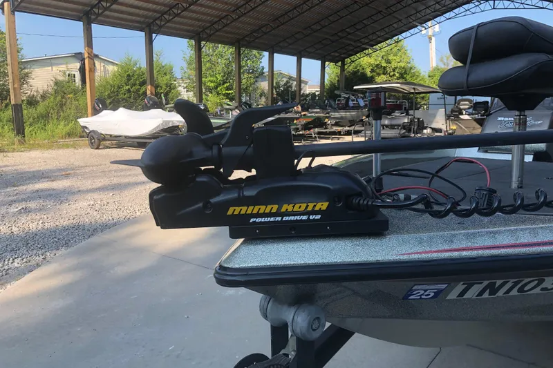 Slide: The Image of 1993 Ranger Comanche 482v boat with Minn Kota Power Drive V2 motor in a covered storage area. - 6