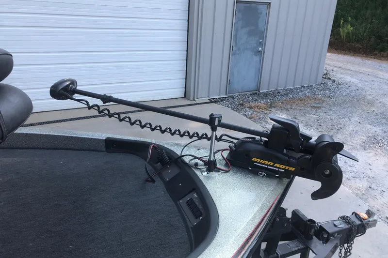 Slide: The Image of 1993 Ranger Comanche 482v boat with Minn Kota trolling motor in a garage setting. - 7