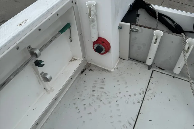 Slide: The Image of 1993 Angler 22 Walk Around boat interior with rod holders and utility compartments. - 4