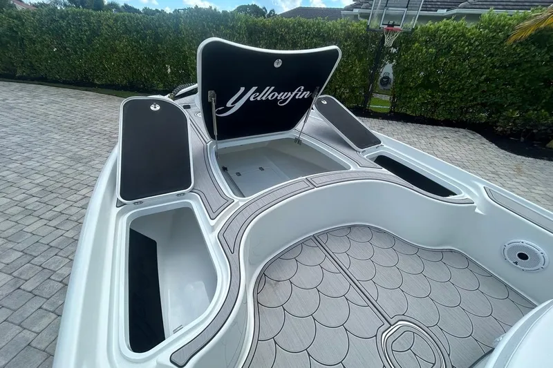 Slide: The Image of 2016 Yellowfin 24 Bay boat interior with open storage compartments and stylish flooring. - 10