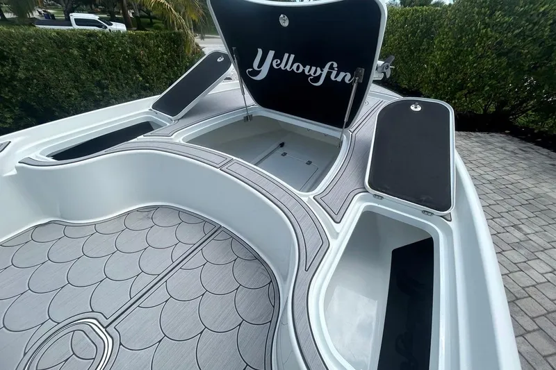 Slide: The Image of 2016 Yellowfin 24 Bay boat interior with open storage compartments and custom flooring. - 11