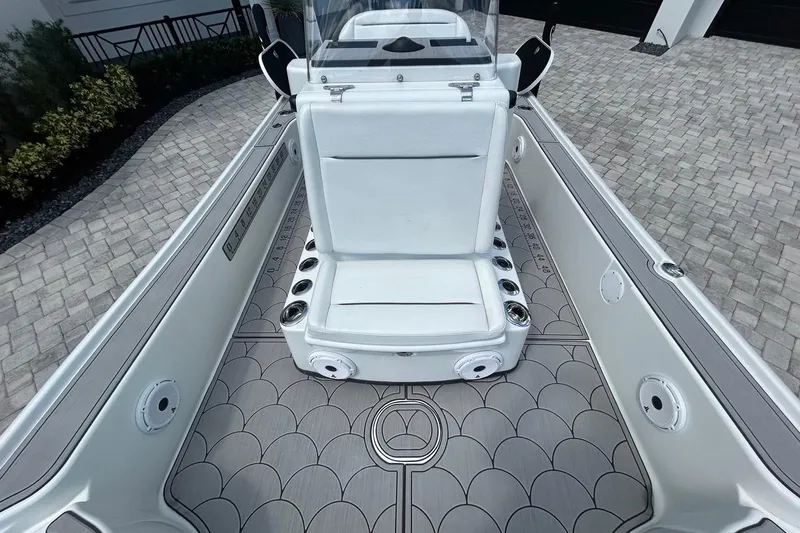 Slide: The Image of 2016 Yellowfin 24 Bay boat interior with white seating and patterned flooring. - 13