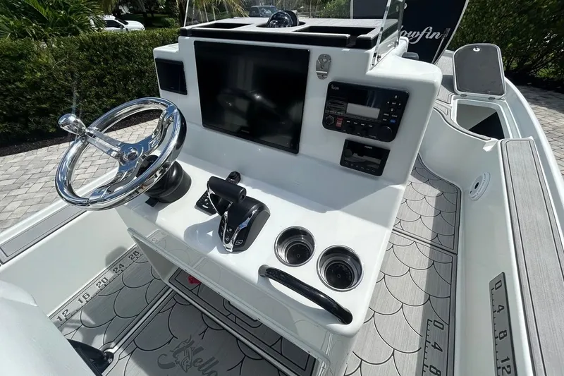 Slide: The Image of 2016 Yellowfin 24 Bay boat dashboard with steering wheel and electronic controls. - 15