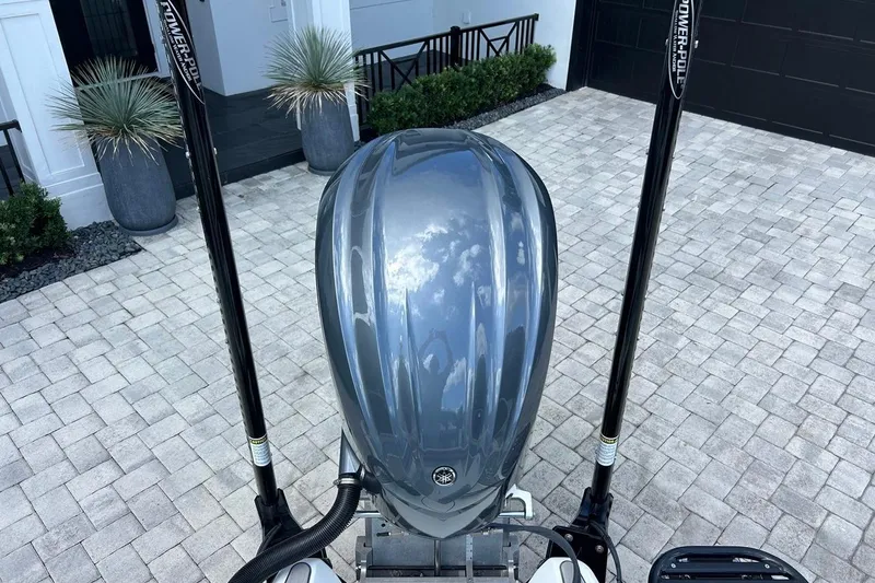 Slide: The Image of 2016 Yellowfin 24 Bay boat with Power-Pole anchors on a paved driveway. - 19