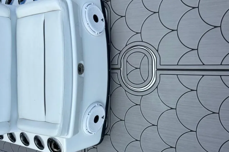 Slide: The Image of 2016 Yellowfin 24 Bay boat interior with white seating and patterned flooring. - 24